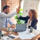 Man and woman giving each other a high five after completing their SAM renewal paperwork